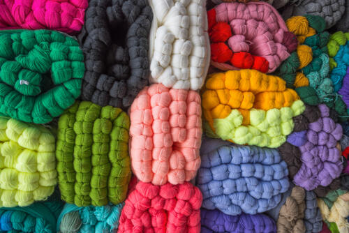 sale of colored skeins of wool yarn in bales